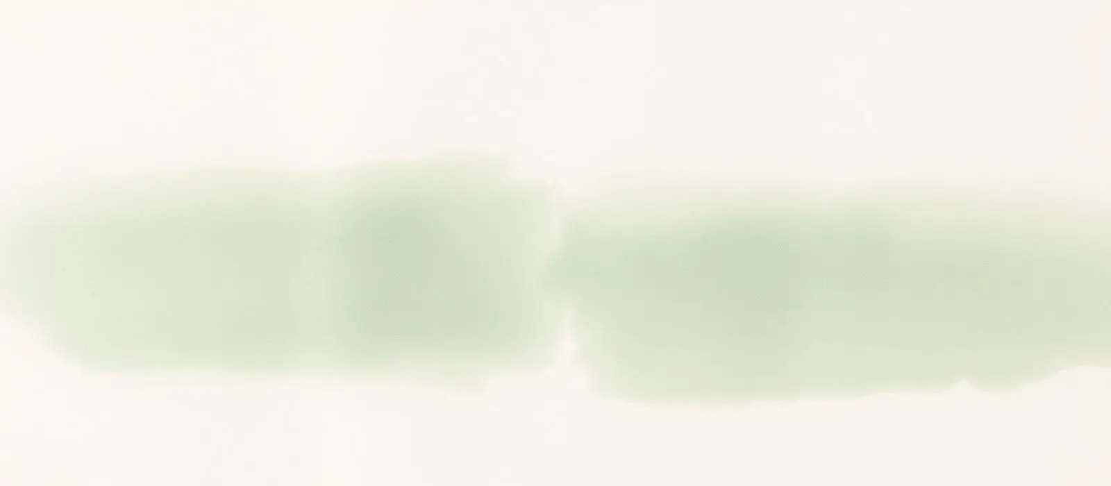 Soft cream paper texture with a pale green ink wash
