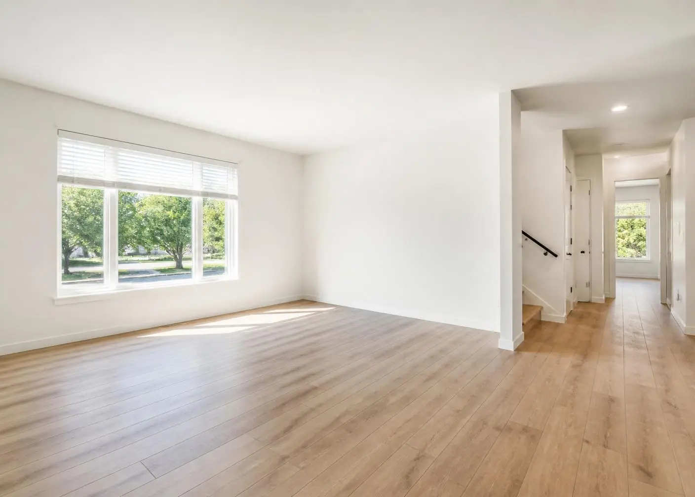 A clean, freshly turned rental living room with natural light